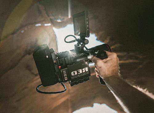 person's hand holding video camera